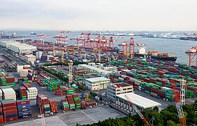 Aerial photograph of the Tokyo sea port showing the shipping containers, cranes and the ocean